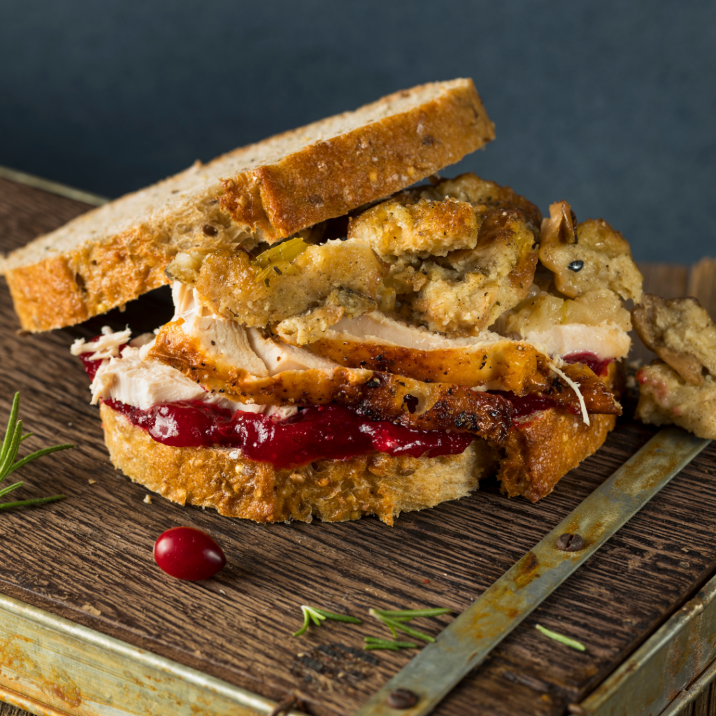 a sandwich using leftover turkey from thanksgiving, along with stuffing, gravy and cranberry sauce