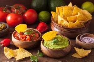 Salsa and guacamole with tortilla chips arranged for cinco de mayo