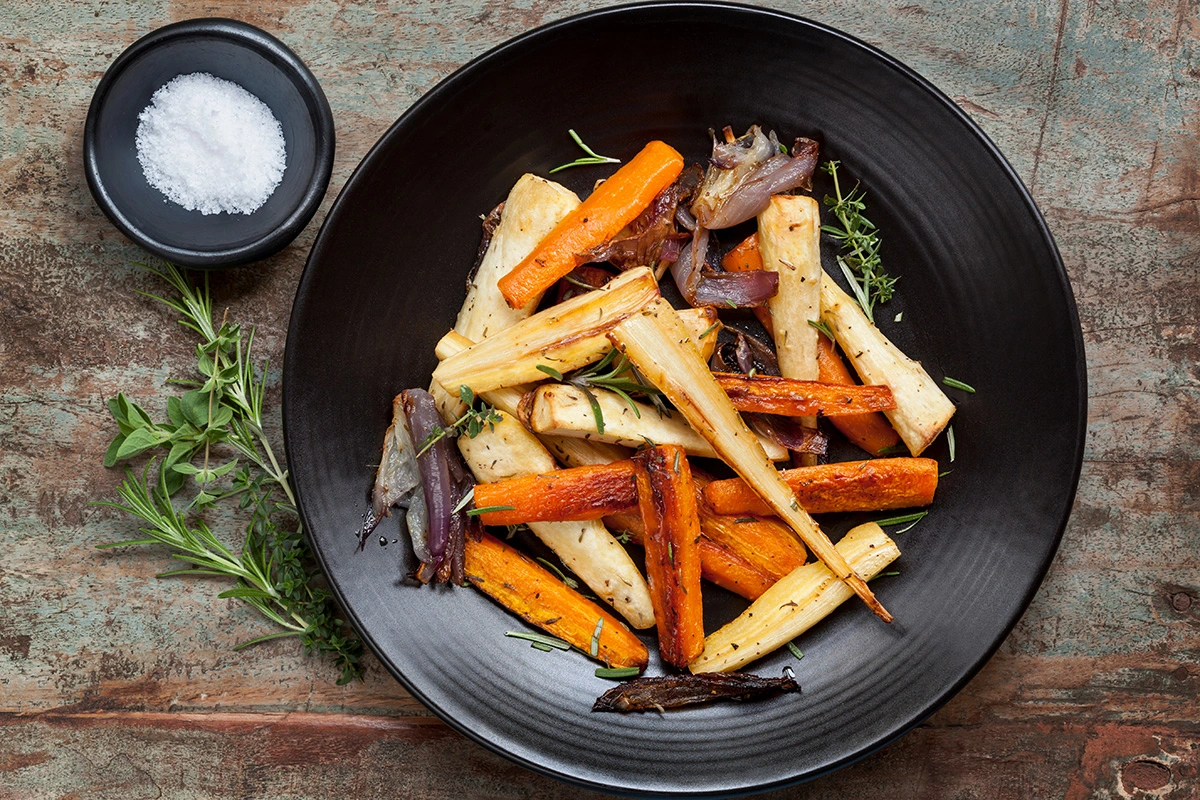 A bowl filled with various roasted Ontario root vegetables