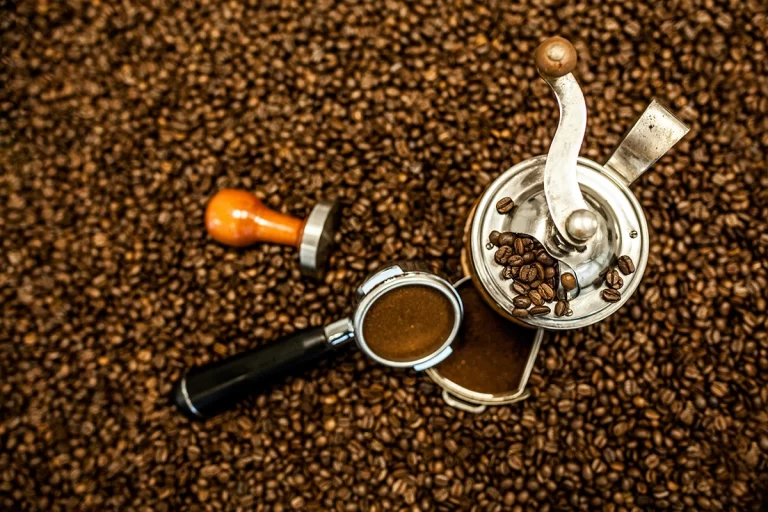 Coffee beans with a grinder and espresso pan. One of the best ways to enjoy Vince's Own coffee.